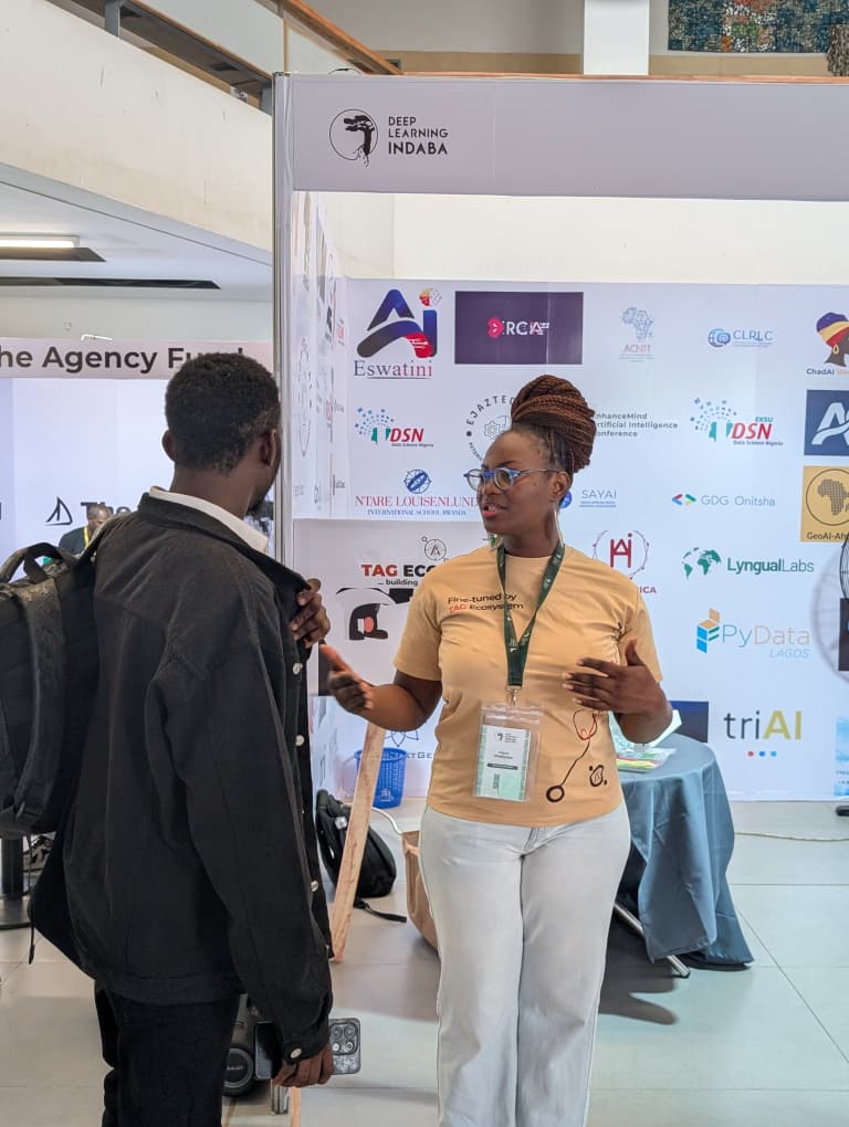 A TAG Ecosystem community member speaking with a new community member at the booth