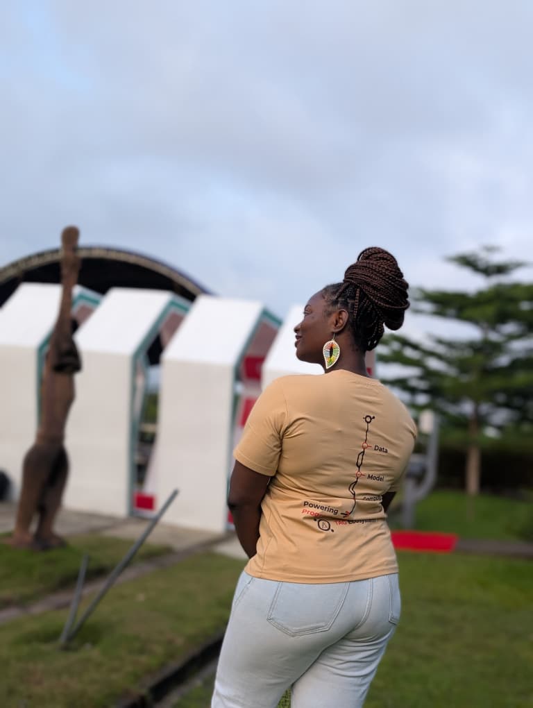 A TAG Ecosystem community member in branded merch outside the Deep Learning Indaba Nigeria 2026 venue
